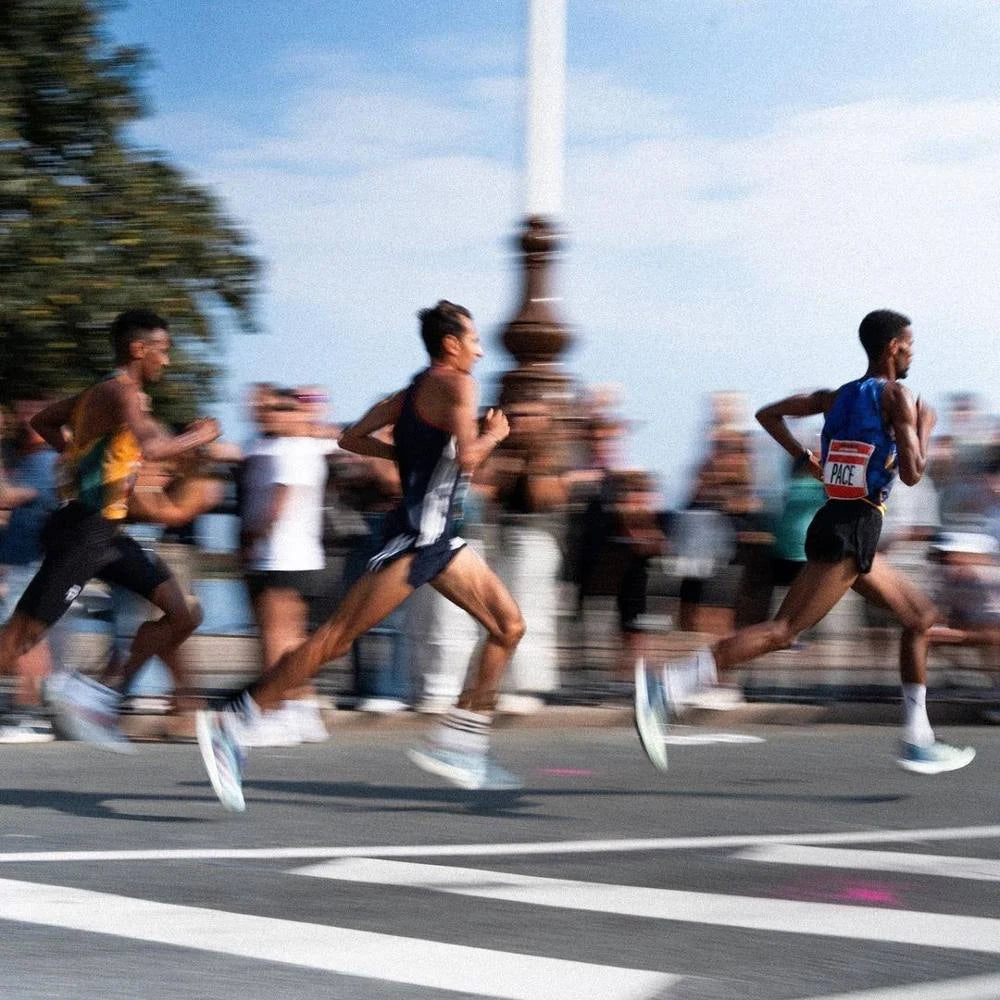 Marathon runners racing along a city road
